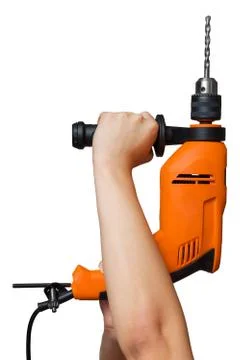 The hands hold the impact drill. vertical photo Stock Photos