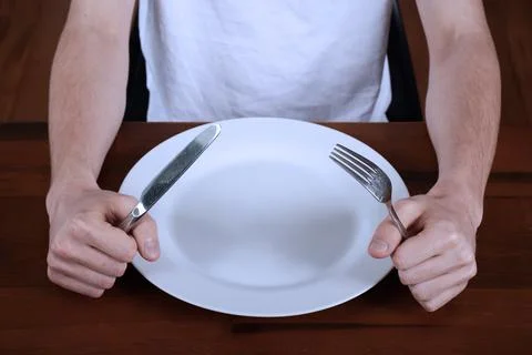 Hands hold a knife and fork Stock Photos
