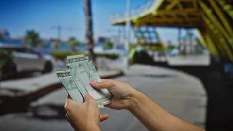 Hands hold malaysian ringgit banknotes, outdoors on an urban city street sh.. Stock Footage 301125306