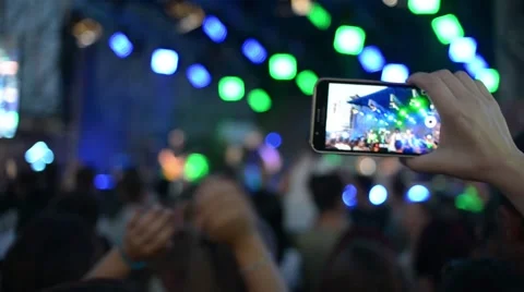 Hands Hold Mobile Camera With Digital Display Among People During Rock Concert Stock Footage 68696973