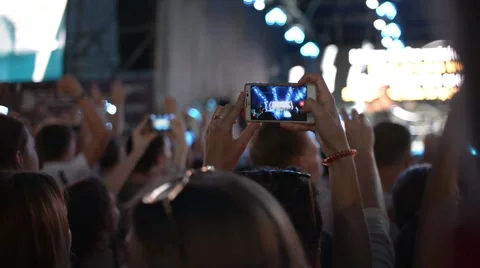 Hands Hold Mobile Camera With Digital Display Among People During Rock Concert Stock-Footage 68697079
