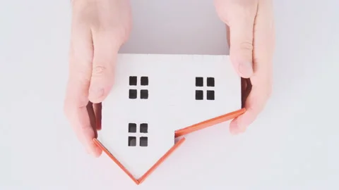 Hands hold model of house on white background top view Video stock 172484709