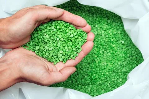 Hands hold or touching biodegradable plastic pellets, plastic polymer granules Stock Photos