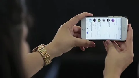 HANDS HOLD A PHONE HORIZONTALLY Stock Footage 130946696