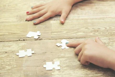 Hands hold puzzles Stock Photos