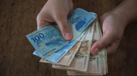 Hands hold real cedulas Stock Photos