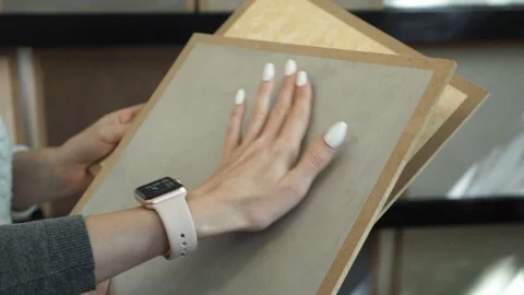 Hands hold samples of interior decoration materials and make a choice Stock Footage 98071609