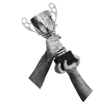 Hands hold a silver trophy high in the air, celebrating victory at a compet.. Stock Photos