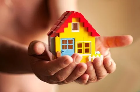 Hands hold a small house Stock Photos