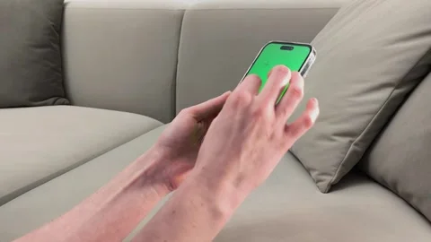 Hands hold smartphone with green screen and perform pinch zoom gesture on d.. Stock Footage 336276155