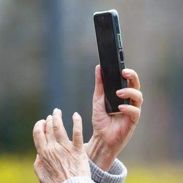 Hands hold smartphone vertically Stock Photos