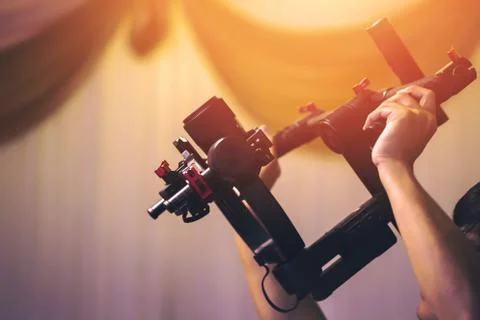 Hands hold stabilizer to take a video. Stock Photos