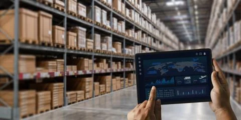 Hands hold a tablet dashboard in a warehouse aisle to track inventory, moni.. Stock Photos
