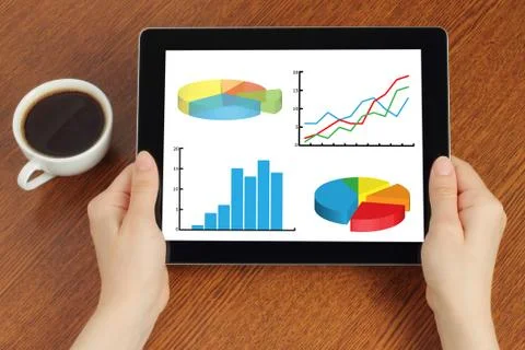 Hands hold tablet pc with graphs . Stock Photos