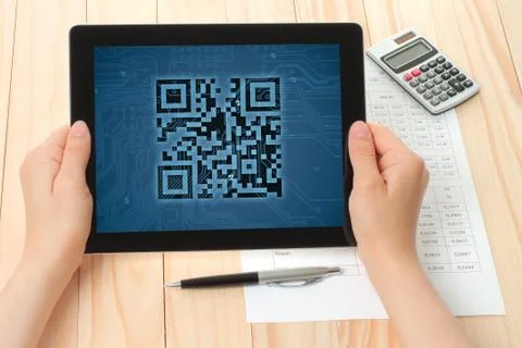 Hands hold tablet pc with qr code. Stock Photos