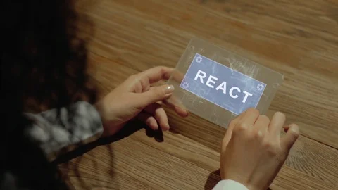 Hands hold tablet with text React Video stock 108464208