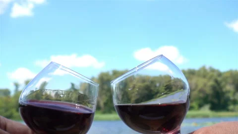 Hands hold two wine glasses in slow motion Stock Footage 153211978