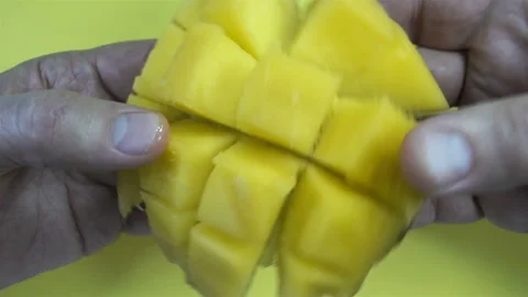 Hands hold yellow mango fruit pulp in 4K Stock Footage 143134122