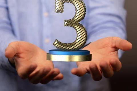 Hands holding a 3D render of a third place trophy 스톡 사진