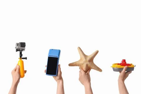 Hands holding action camera, payment terminal, starfish, and toy boat Stock Photos
