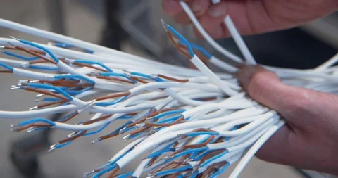 Hands holding and examing a bunch of exposed electric wires, close up Stock Footage 154798686