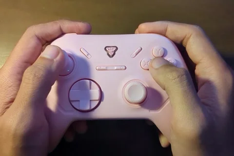 Hands holding and playing with a video game controller Stock Footage 338145933