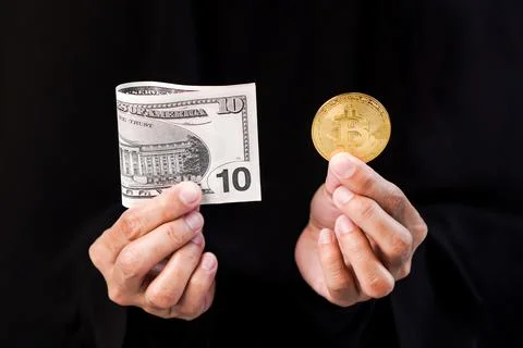 A hands holding and presenting a single folded ten dollar on the left side .. Stock Photos
