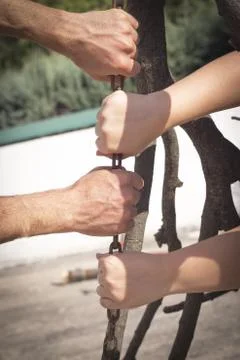 Hands holding and pulling a stick Foto stock