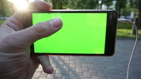 Hands holding and using business smartphone CHROME KEY. Fingers make gestures on Stock Footage 75688897