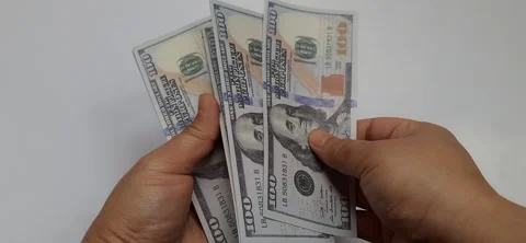 Hands holding assorted United States Dollar Bills Stock Footage 321024321