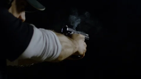 Hands holding an automatic pistol after firing, Ultra Slow Motion Stock Footage 86584692