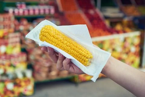 Hands Holding Boiled Corn Stock Photos