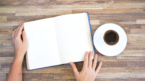 Hands holding book Stock Footage 112300025