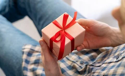 Hands holding a brown gift box with red ribbon. Christmas, New Year, Valent.. Stock Photos