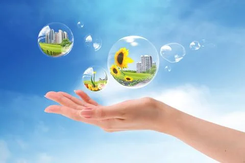 Hands holding bubbles against a blue sky Fotos de archivo