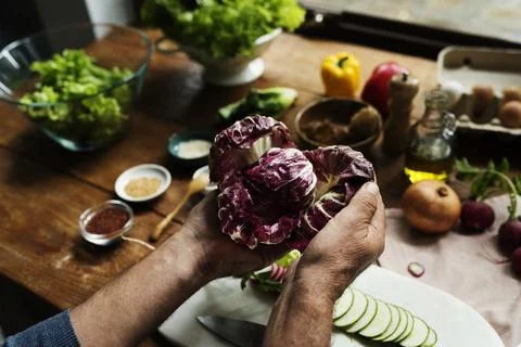 Hands holding cabbage in a kitchen Stock Photos