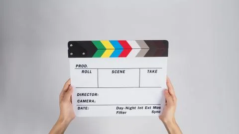 Hands is holding Clapper board or movie slate. it use in video production and Stock Photos