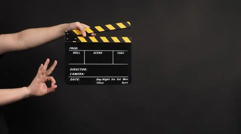 Hands is holding clapper board or movie slate.It is used in video production  Stock Photos