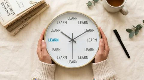 Hands Holding Clock with LEARN Text Education and Self Improvement Concept 库存照片