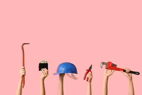 Hands holding construction tools and wallet with money, labor and financial c Stock Photos
