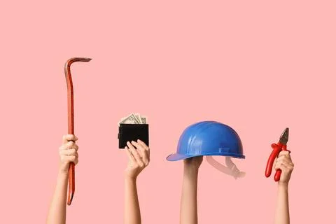 Hands holding construction tools and wallet with money, labor and financial s Stock Photos