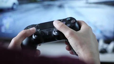Hands holding controller, pressing buttons on game joystick and playing TV game Stock Footage 160327577