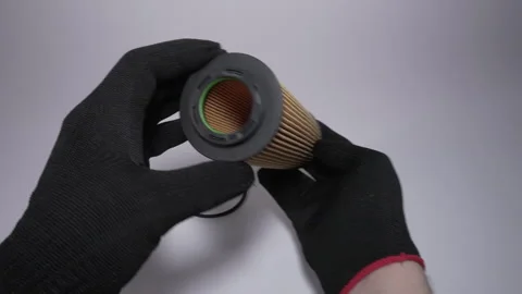 Hands Holding a Cylindrical Object with Protective Gloves for Safety Vidéo 303811375