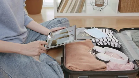 Hands holding digital tablet with application booking flight and hotel. Stock-Footage 138795070