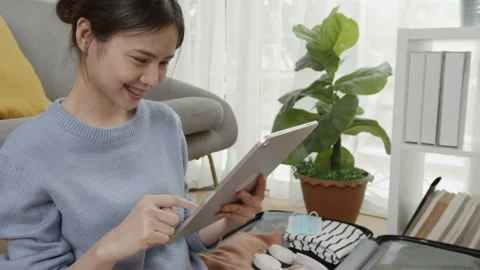 Hands holding digital tablet with application booking flight and hotel. Stock-Footage 138795824