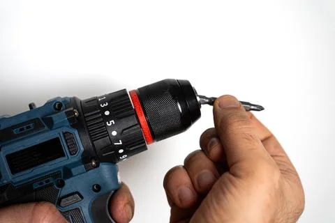 Hands holding drill bit for power tool installation Stock Photos