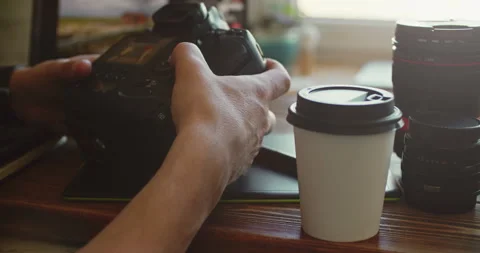 Hands Holding DSLR Camera Over Coffee Cup on Wooden Table Stock Footage 308378986