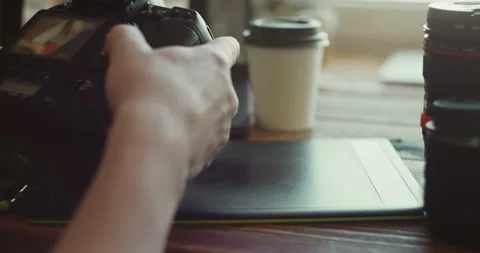 Hands Holding DSLR Camera Over Coffee Cup on Wooden Table Stock Footage 308381750