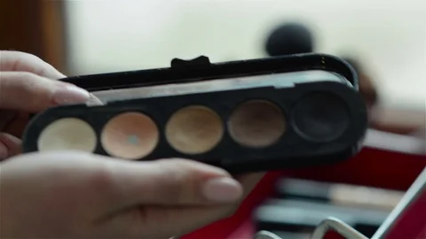 Hands holding an eyeshadow palette Stock Footage 70922780