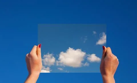 Hands holding a frame with clouds Stock Photos